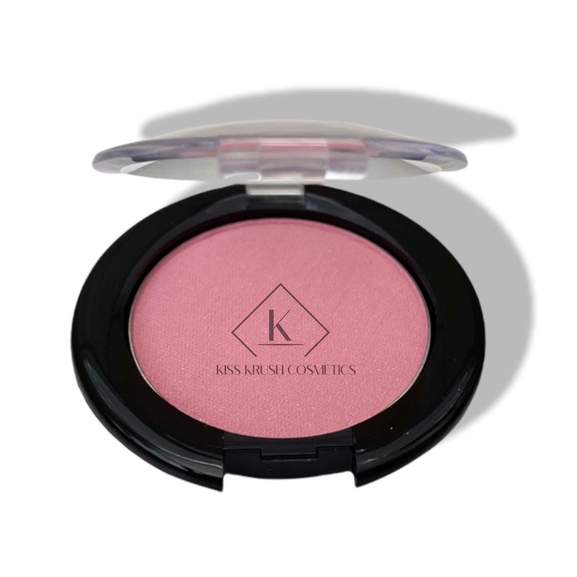 A pan of pressed blush makeup with a pink shade, labeled with the brand Kiss My Cosmetics.